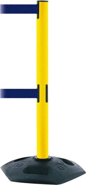 Tensator - 38" High, 2-1/2" Pole Diam, 4 Way Stanchion - 19" Base Diam, Octagon Recycled Rubber Base, Yellow Plastic Post, 7-1/2' x 2" Tape, Dual Line Tape, For Outdoor Use - Eagle Tool & Supply