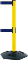Tensator - 38" High, 2-1/2" Pole Diam, 4 Way Stanchion - 19" Base Diam, Octagon Recycled Rubber Base, Yellow Plastic Post, 7-1/2' x 2" Tape, Dual Line Tape, For Outdoor Use - Eagle Tool & Supply