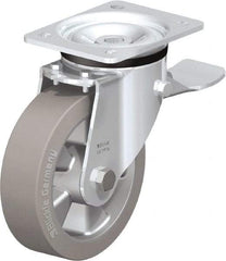 Blickle - 6-1/2" Diam x 1-31/32" Wide x 7-61/64" OAH Top Plate Mount Swivel Caster with Brake - Solid Rubber, 880 Lb Capacity, Ball Bearing, 5-1/2 x 4-3/8" Plate - Eagle Tool & Supply
