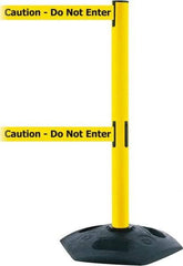 Tensator - 38" High, 2-1/2" Pole Diam, 4 Way Stanchion - 19" Base Diam, Octagon Recycled Rubber Base, Yellow Plastic Post, 7-1/2' x 2" Tape, Dual Line Tape, For Outdoor Use - Eagle Tool & Supply