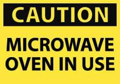 NMC - Accident Prevention Label, Header: CAUTION - Legend: Caution - Microwave Oven in Use, English, Black & Yellow, 5" Long x 3" High, Sign Muscle Finish - Eagle Tool & Supply